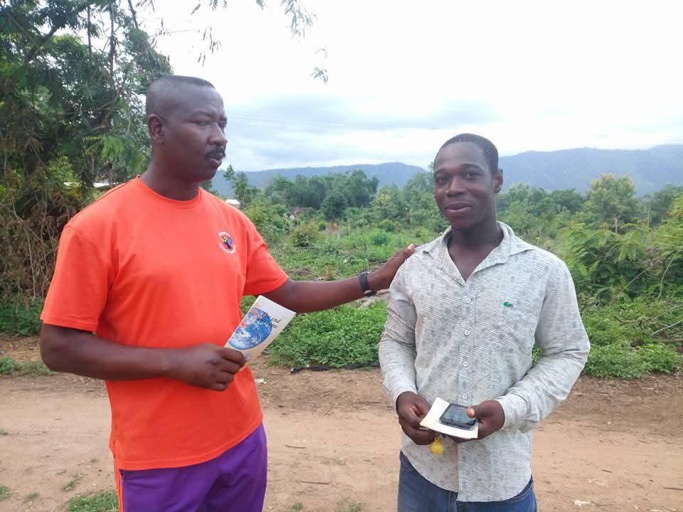 A church member sharing the Gospel with a community member