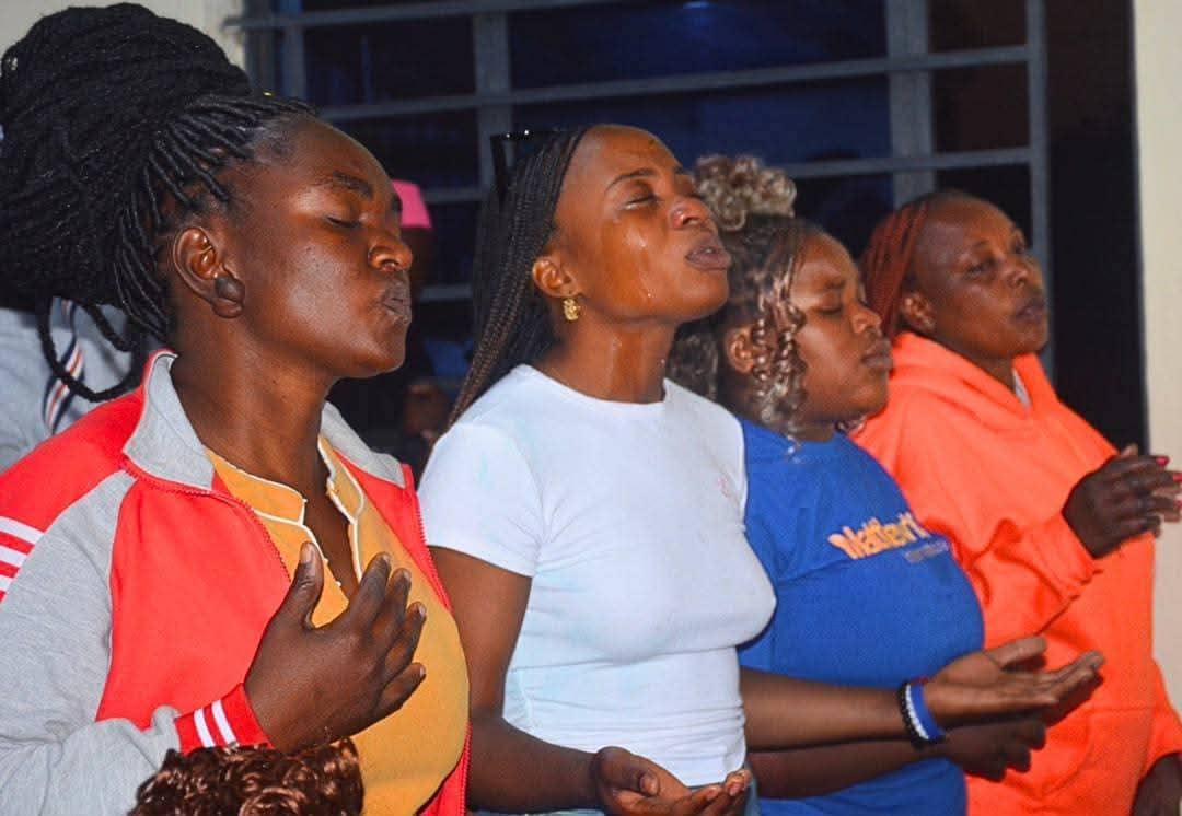 Church members praying together during worship