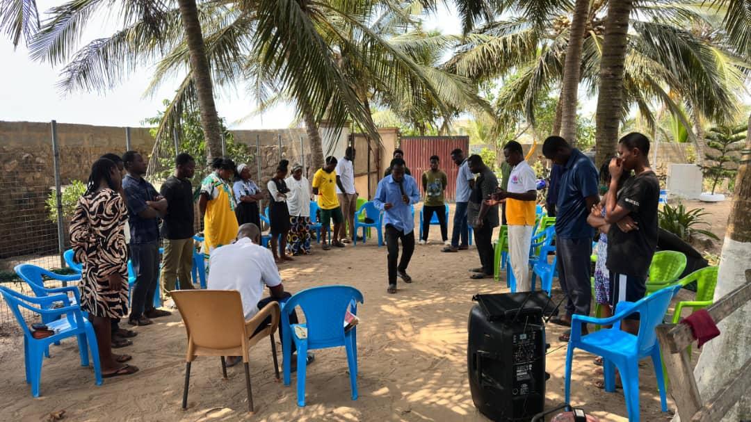 Young people gathered outdoors for fellowship and prayer